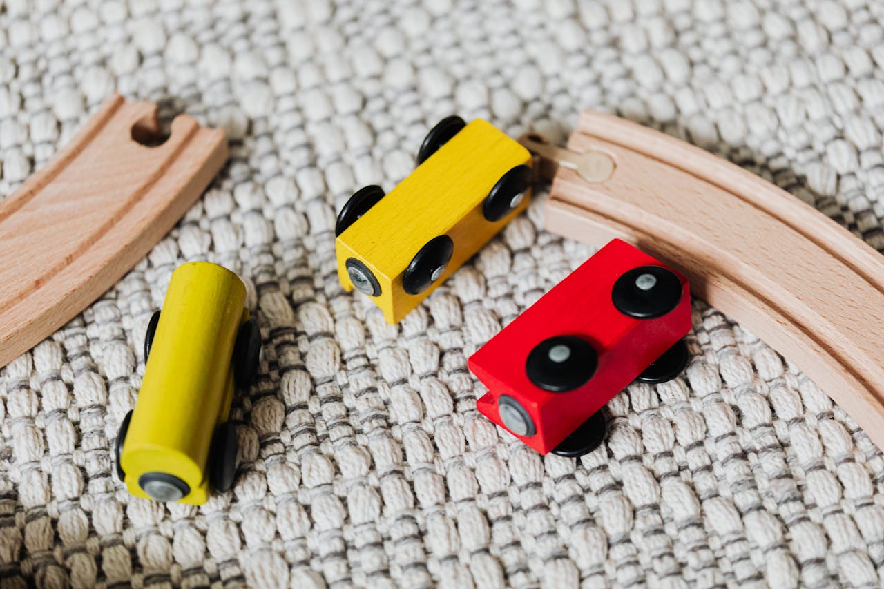 Close-up of a colorful wooden train set on a textured carpet, showcasing vibrant playtime.